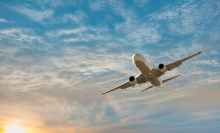 plane flying in cloudy sky