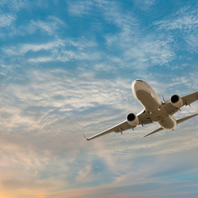 plane flying in cloudy sky