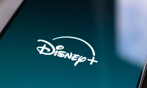 In this photo illustration, the Disney Plus streaming app logo is displayed on the smartphone screen