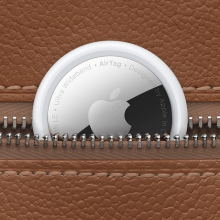 An AirTag peeking out of a leather wallet