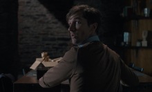 Gwilym Lee as Ted looks behind him with a frightened face in "Oddity." 