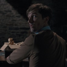 Gwilym Lee as Ted looks behind him with a frightened face in "Oddity." 