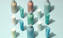 Bottled personal care products on turquoise backdrop