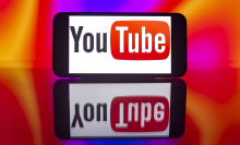 A phone screen displaying the YouTube logo mirrored. 