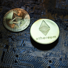 two physical coins marked with the Ethereum logo