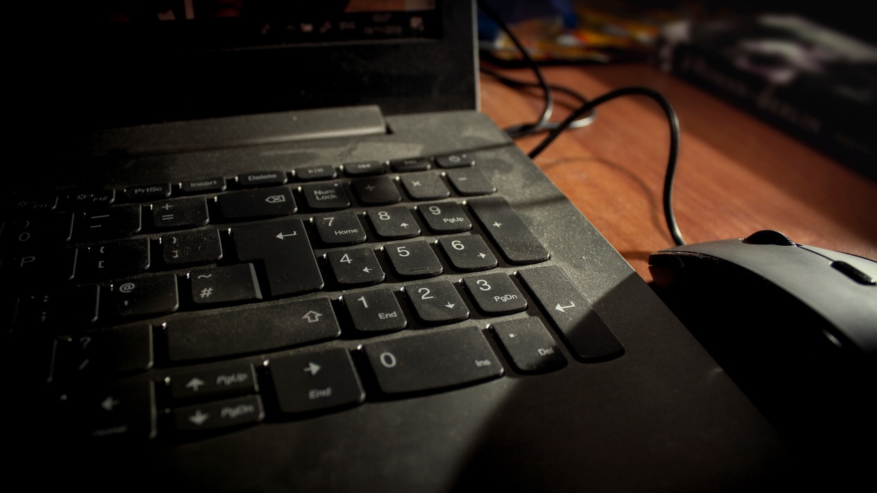 A dusty laptop and mask