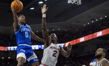 Rob Dillingham #0 of the Kentucky Wildcats looks to pass the ball in front of Jaylin Williams #2 of the Auburn Tigers during the first half of play at Neville Arena on Feb. 17, 2024, in Auburn, Alabama.