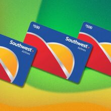 three southwest airlines gift cards appear in a line on a diagonal. the background is wavy yellow and green