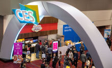 CES entry arch with people milling below