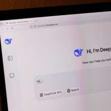 A desktop computer shows the DeepSeek chatbot homepage.
