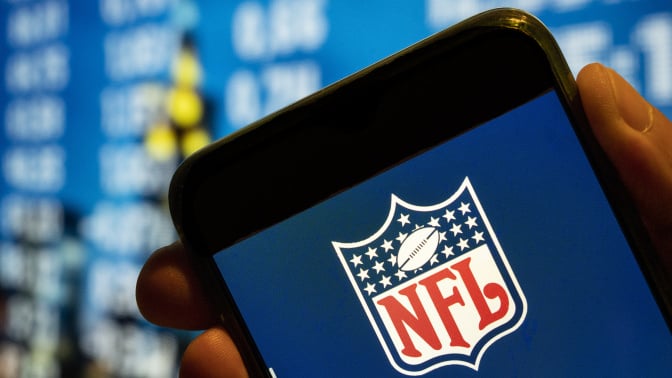 nfl logo on screen of iphone with blue background