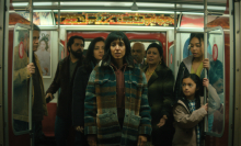 A family stands in a subway car in the TV show "The Umbrella Academy."