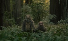 Jesse Eisenberg and Christophe Zajac-Denek play a pair of sasquatch, holding hands.