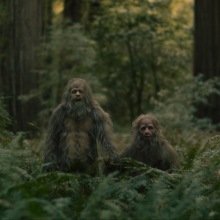 Jesse Eisenberg and Christophe Zajac-Denek play a pair of sasquatch, holding hands.