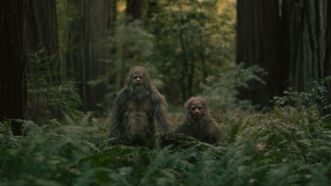 Jesse Eisenberg and Christophe Zajac-Denek play a pair of sasquatch, holding hands.