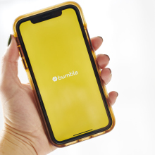 logo for Bumble is displayed on a smartphone