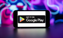 Google play store logo is seen displayed on a mobile phone screen.