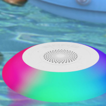 Rainbow LED speaker floating in pool