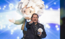 Marc Benioff holds a doll.