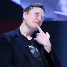 elon musk posing with a finger under his chin