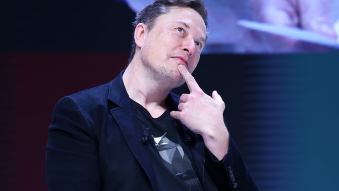 elon musk posing with a finger under his chin