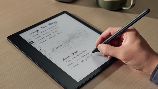 a right hand holds a pen over the kindle scribe