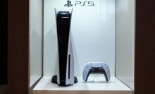 PS5 and controller in display case