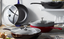 A collection of Staub cast iron pans in a kitchen.