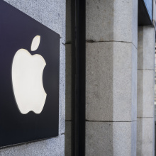 The Apple logo affixed to the side of a building.