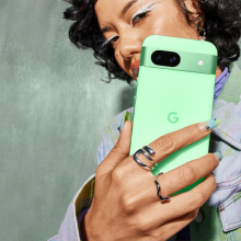 girl holding aloe google pixel 8a phone with colorful shirt and nails