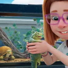 A red-headed girl holds a pet lizard. 