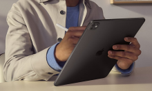 a close-up of a man writing on a 2024 apple ipad pro using an apple pencil pro
