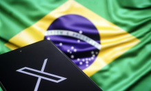 x logo on phone in front of brazilian flag