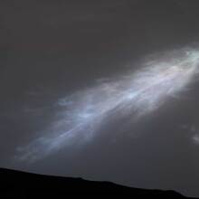 An iridescent cloud hovering high above the Martian surface