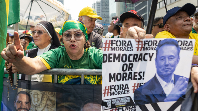 brazil rallygoes with a sign that has a picture of elon musk