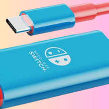 The Nintendo Switch conversion cable overlaid on a gradient background, in blue and coral colors.