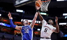 Kyle Filipowski of the Duke Blue Devils and Brandon Huntley-Hatfield of the Louisville Cardinals battle for a rebound at KFC YUM! Center on January 23, 2024, in Louisville, Kentucky.