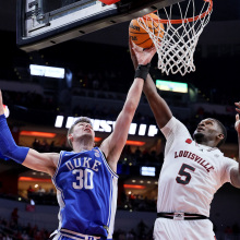 Kyle Filipowski of the Duke Blue Devils and Brandon Huntley-Hatfield of the Louisville Cardinals battle for a rebound at KFC YUM! Center on January 23, 2024, in Louisville, Kentucky.