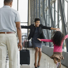 a mother greeting her daughter at in an airport terminal