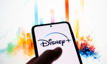 In this photo illustration a Disney + logo is seen displayed on a smartphone. 