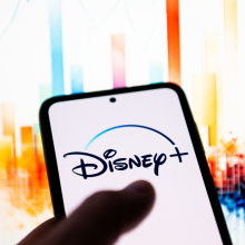 In this photo illustration a Disney + logo is seen displayed on a smartphone. 