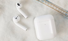 second generation airpods and case on denim