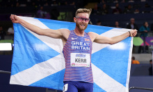 Josh Kerr holding Scottish flag at World Athletics Indoor Championships