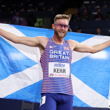 Josh Kerr holding Scottish flag at World Athletics Indoor Championships