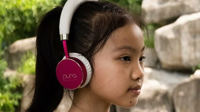 young girl wearing Puro Sound Labs headphones