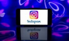 In this photo illustration, an Instagram logo is seen displayed on a mobile phone screen.