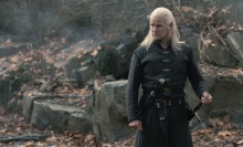 Daemon Targaryen stands in the courtyard at Harrenhal, one hand on his sword.