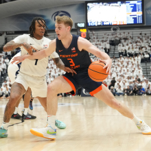 Marcus Domask #3 of the Illinois Fighting Illini dribbles by Ace Baldwin Jr. #1 of the Penn State Nittany Lions in the first half during a college basketball game on Feb. 21, 2024, in University Park, Pennsylvania.