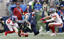 Dareke Young of the Seattle Seahawks grabs a fumble