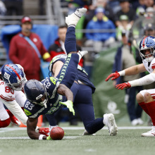 Dareke Young of the Seattle Seahawks grabs a fumble